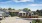 a group of houses with cars parked in front of them