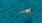 overhead shot of a woman swimming in a pool